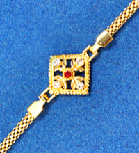 Golden Rakhi Bracelet with White And Red Stones